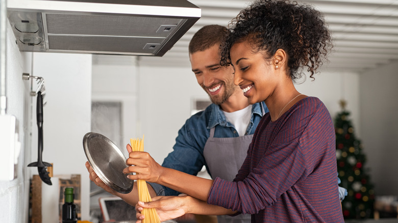 Couple cooking in kitchen