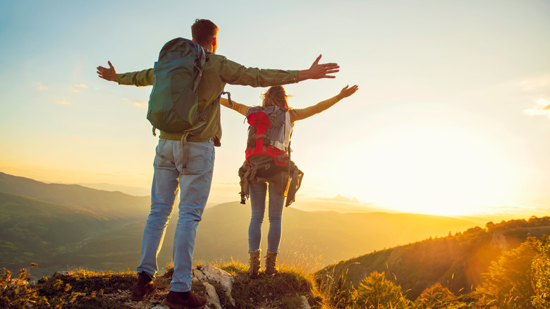 Couple hiking on top of a mountain