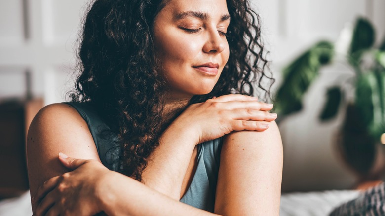 Woman holding herself