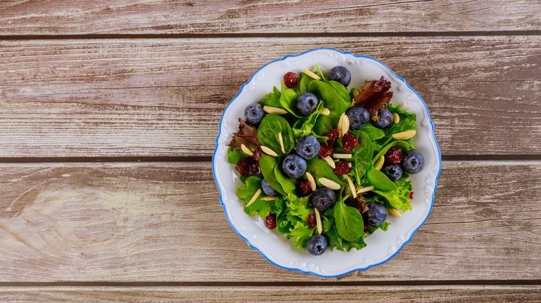 Spinach salad with cranberries, blueberries, and almonds