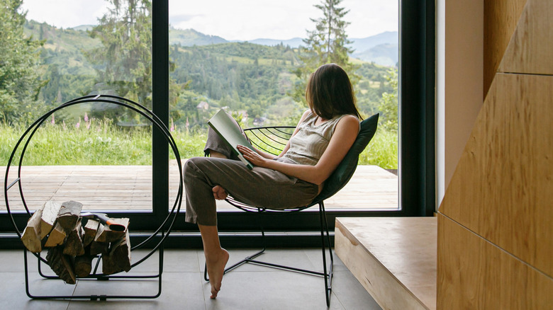 woman reading book in chair