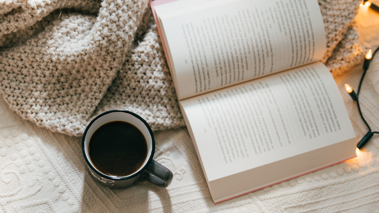 book open with lights and a mug