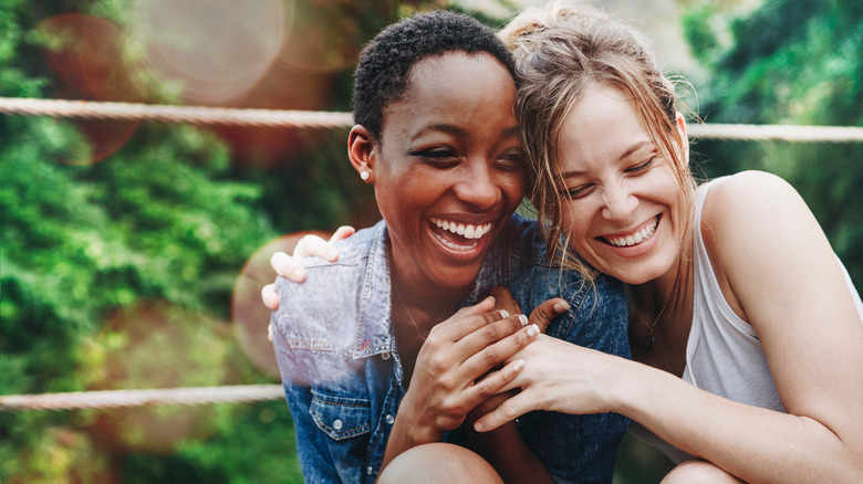 Two friends embracing in a garden