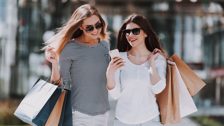 Two friends shopping with sunglasses