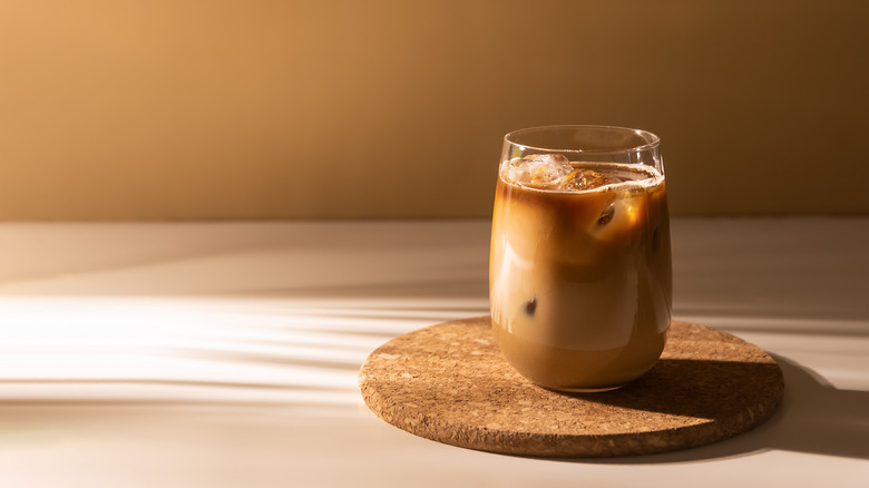 Glass of cold brewed coffee on a wooden tray