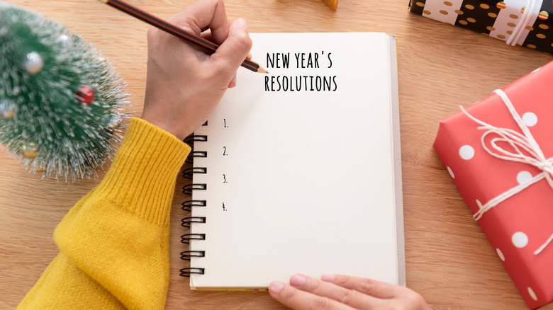 Woman writing her New Year's resolutions