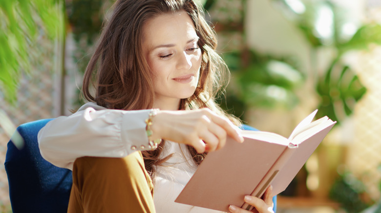 Women reading a book outdoors