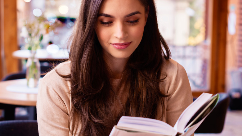 Woman brown hair reading