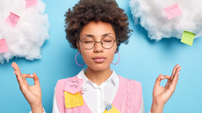 Woman meditating with post-it notes 