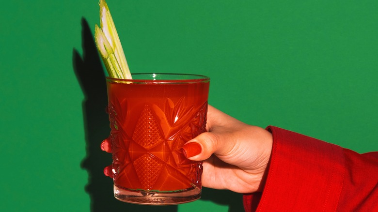 Woman holds a Bloody Mary