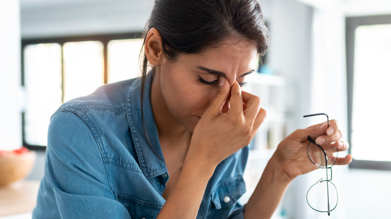 Woman pinching bridge of nose