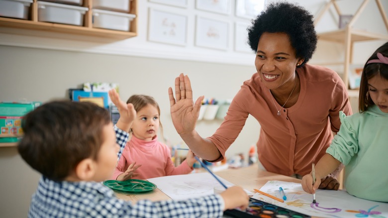 teacher working with young students