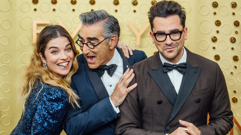 Schitt's Creek stars Annie Murphy, Eugene Levy, and Dan Levy at an event.