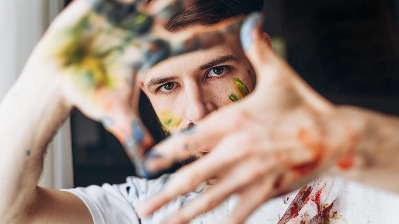 Man with paint stained hands