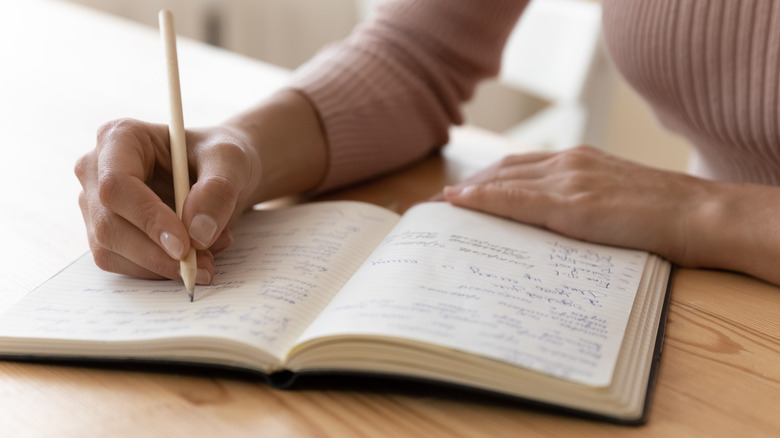 Woman writing in a notebook