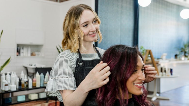 Woman styling customer's hair