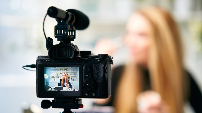 Young woman filming an influencer post