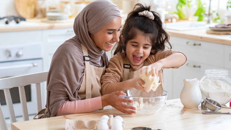 Woman baking with daughter 