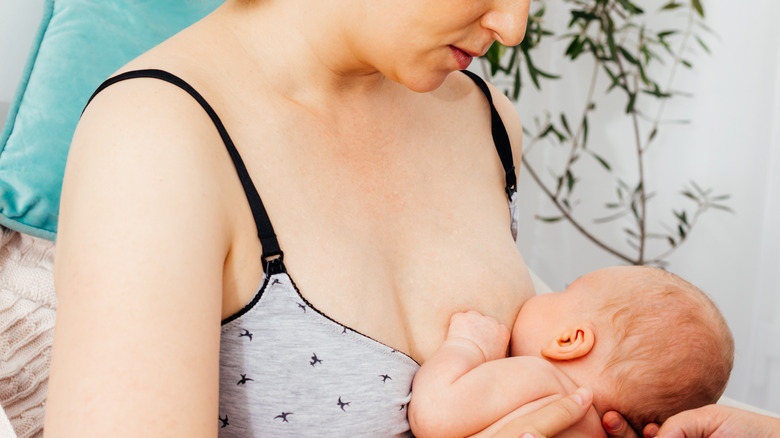 Mom breastfeeds baby