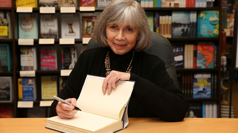 Anne Rice signing an open book