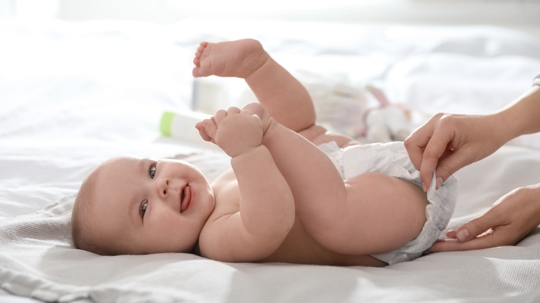 Baby boy having diaper changed