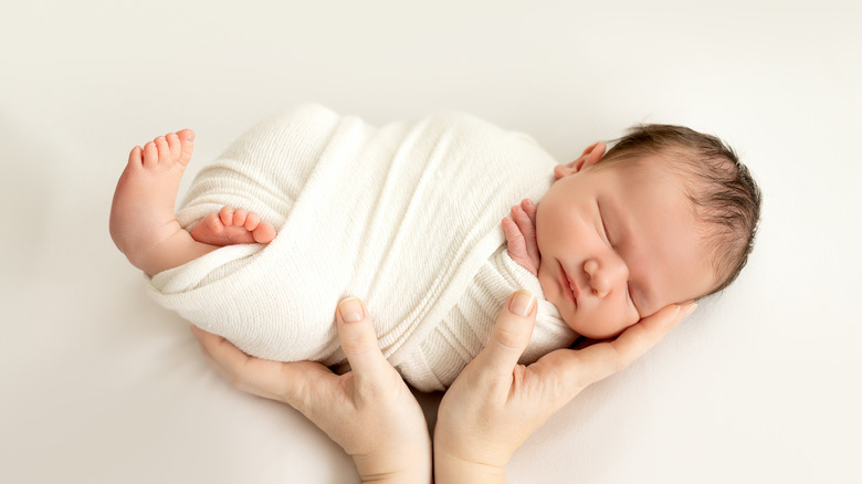 Newborn baby wrapped in towel