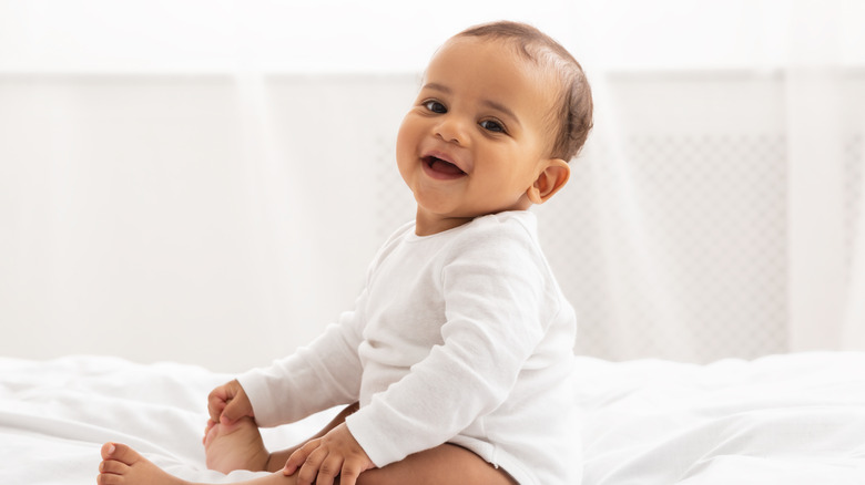 Indian baby boy sitting, smiling