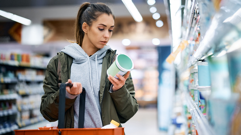 woman reading food label