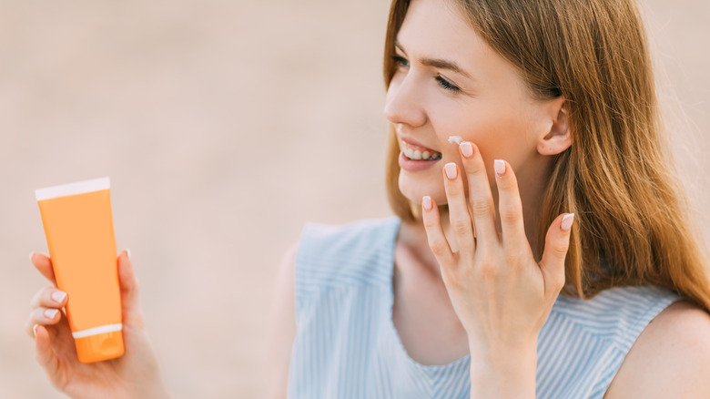 Woman applying sunscreen