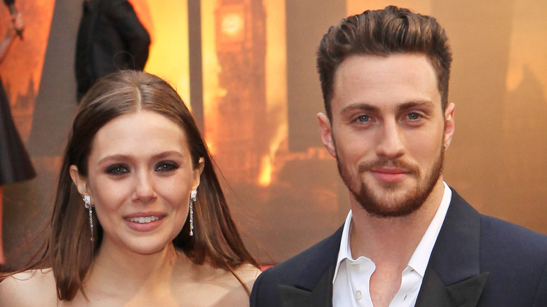 Elizabeth Olsen and Aaron Taylor-Johnson posing