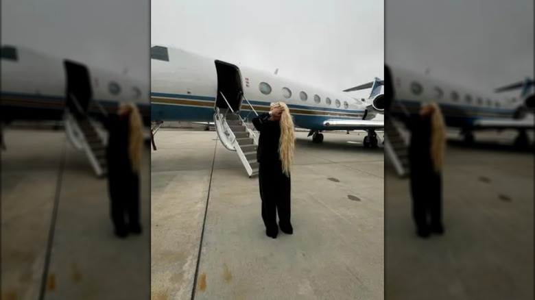 Alabama Parker in front of a private jet