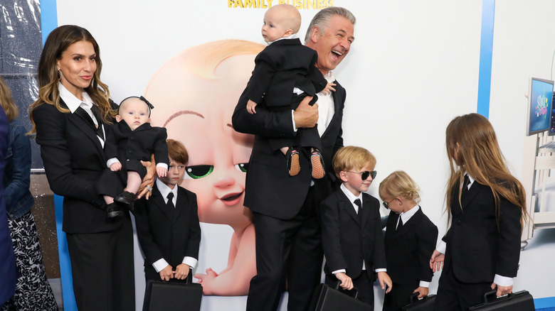 Alec Baldwin holding one of his babies