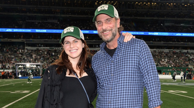 Alexandra Daddario and Andrew Form smiling at a Jets game