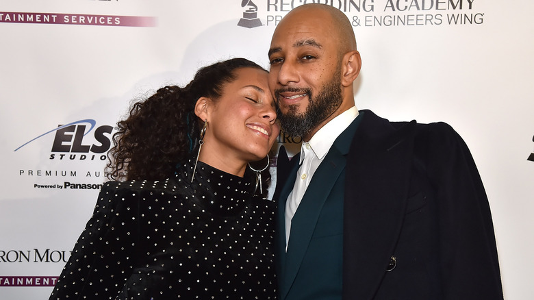 Alicia Keys nuzzling her nose into Swizz Beatz's face