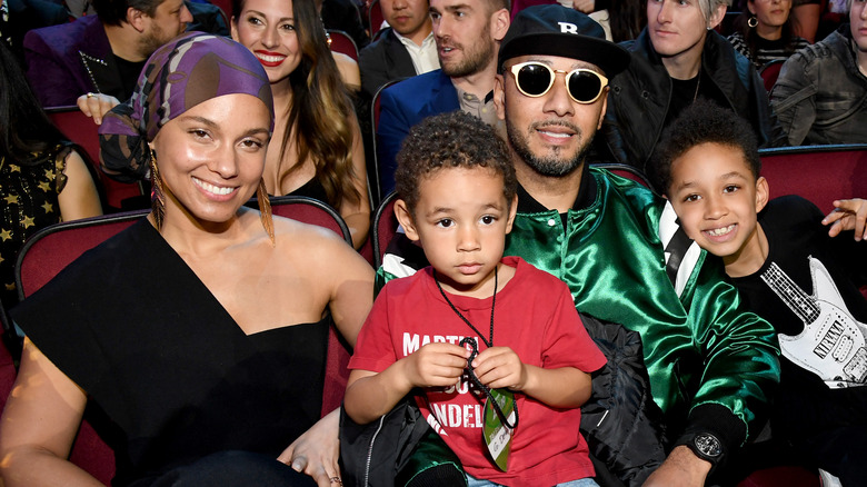 Alicia Keys and Swizz Beatz smiling with their sons