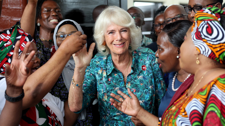 Queen Camilla smiling in group of women