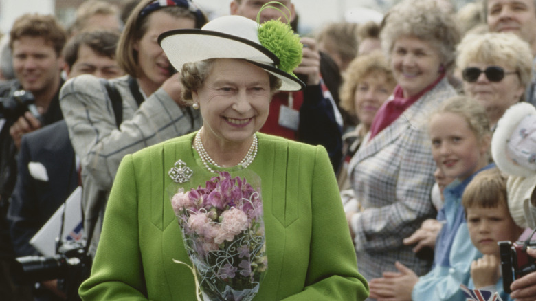 Queen Elizabeth greeting crowds in green suit