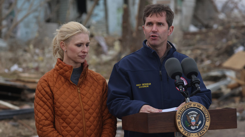 Britainy and Andy Beshear standing at a podium