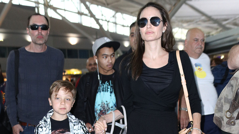 Angelina Jolie, James Haven and her two sons walking
