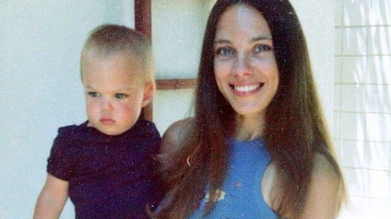Marcheline Bertrand holding baby Angelina Jolie