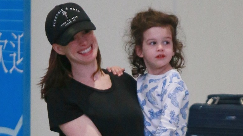 Anne Hathaway holding her son
