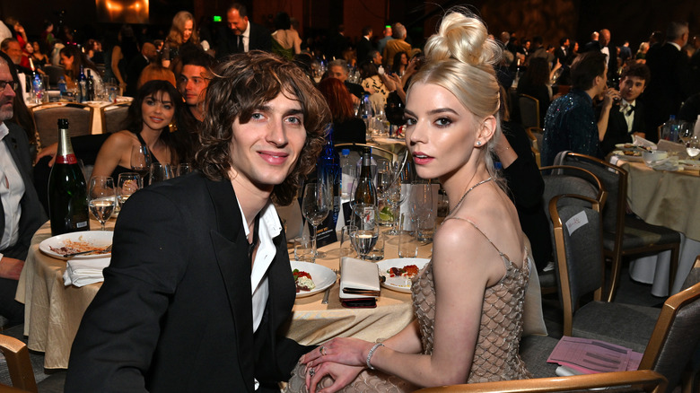 Anya Taylor-Joy and Malcolm McRae at a table