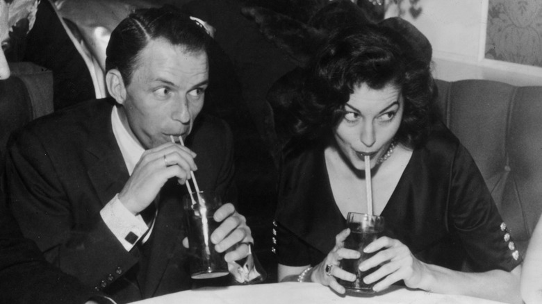 Ava Gardner and Frank Sinatra sipping drinks