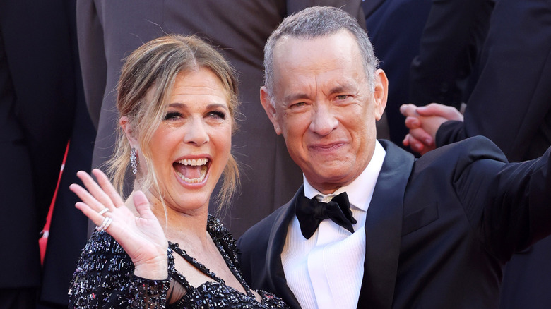 Rita Wilson and Tom Hanks smiling and waving