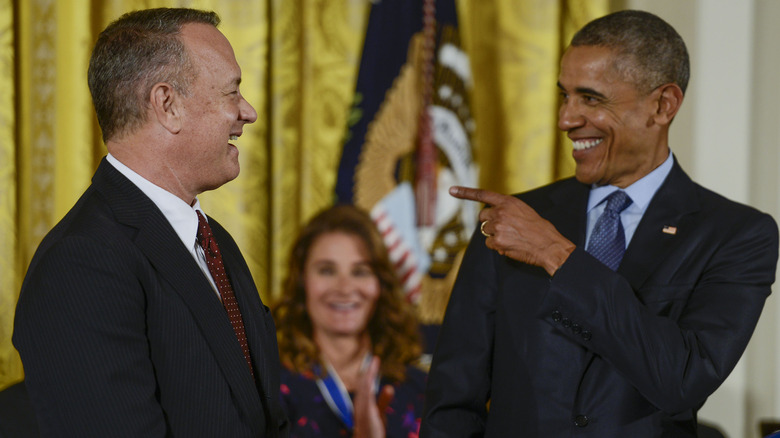 Tom Hanks smiling and Barack Obama pointing