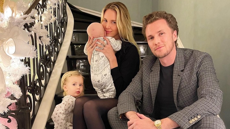 Barron and Tessa Hilton with two kids sitting on stairs