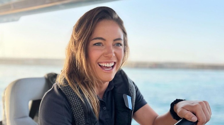 Malia White driving a boat