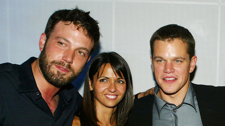 Ben Affleck, Luciana Barroso and Matt Damon pose at the after party for "The Bourne Supremacy" in 2004