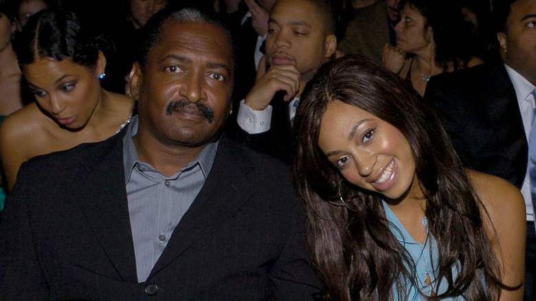 Solange and Mathew Knowles holding hands