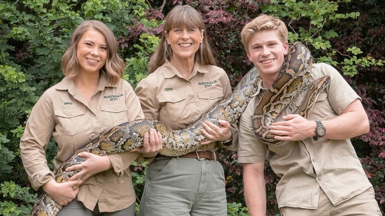 Terri, Bindi and Robert holding a python